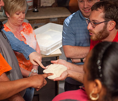 tour guests touch pizza dough