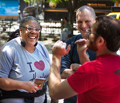 a tour guide explains pizza information to a group of pizza tour guests