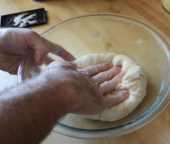 hand kneading pizza dough