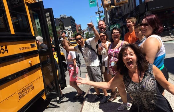 excited pizza tour group getting on bus