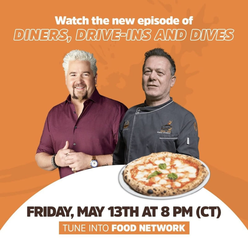 Guy Fieri and Roberto Caporuscio stand with a pizza