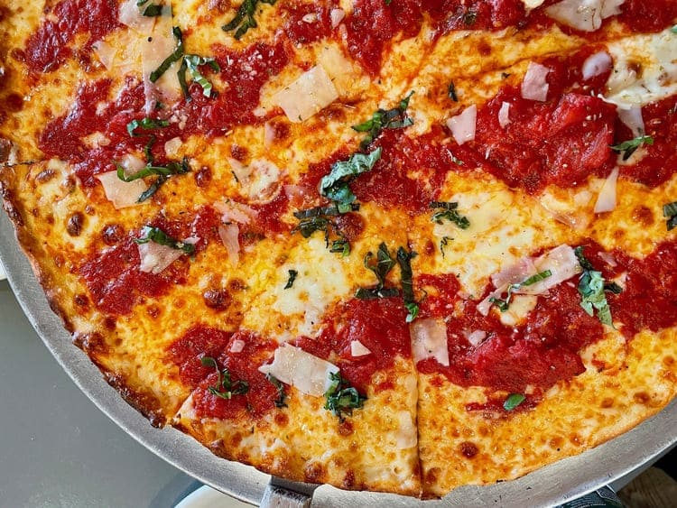 thin pan pizza with chunky tomato and cheese