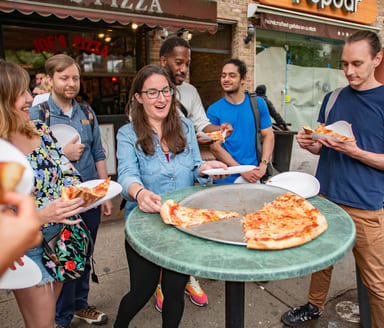 people having fun on a pizza tour in Greenwich Village NYC