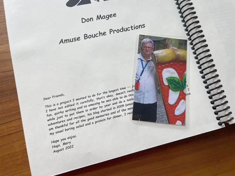 title page of a spiral bound book with a photo of a man with a giant pizza slice