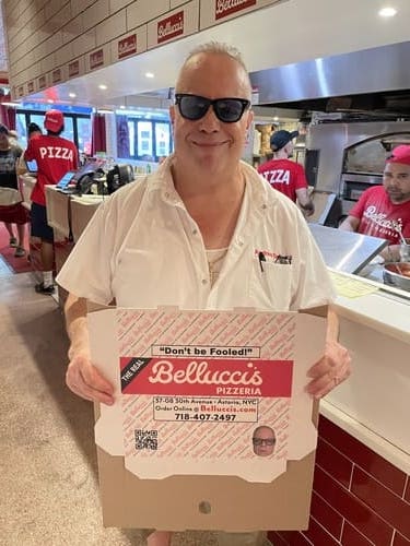 andrew bellucci holding his pizza box