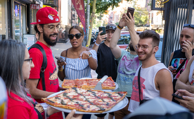 a man leading a pizza tour in New York City