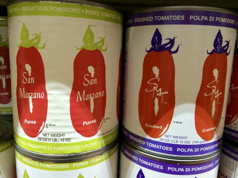 two cans of tomatoes from Simpson Imports showing different branding