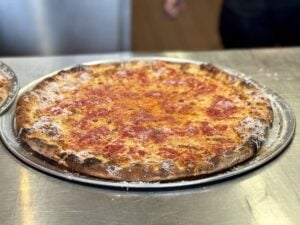 cheese pizza with tomato on top